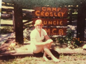 old school Renee in front of Camp Crosley sign