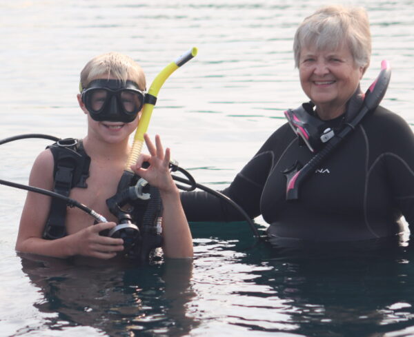 Image of a young boy and an instructor scuba diving.