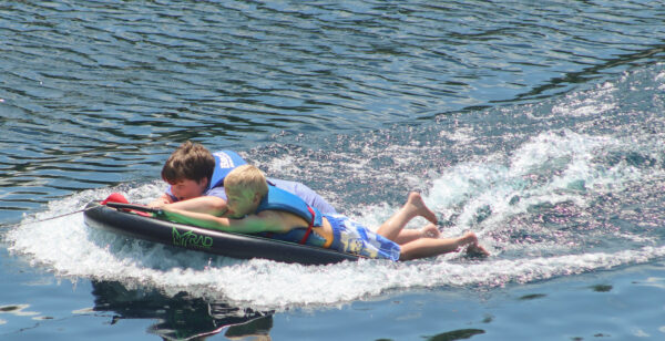 image of two male campers going wakeboarding.