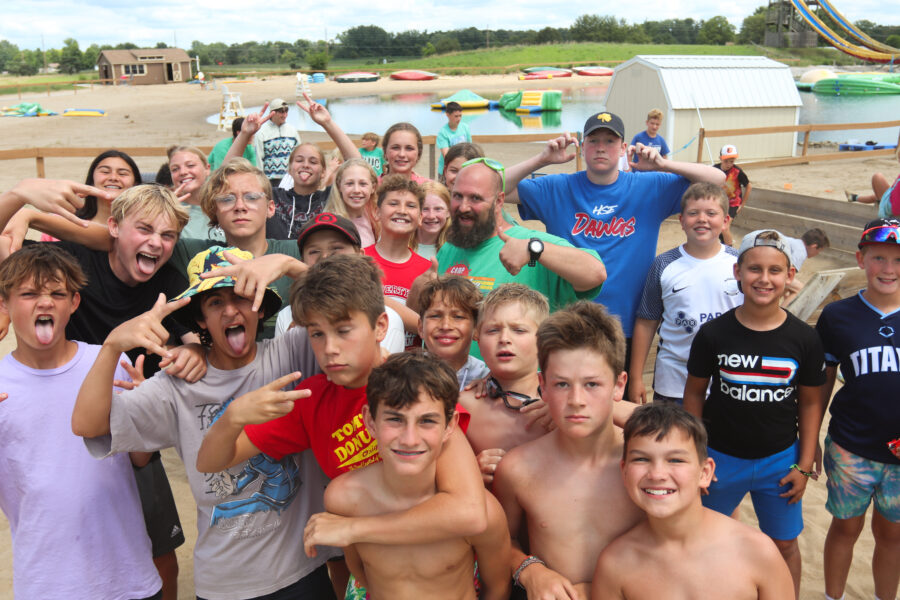 Image of several boys posing for a photo in front of the H2O Woah Zone.