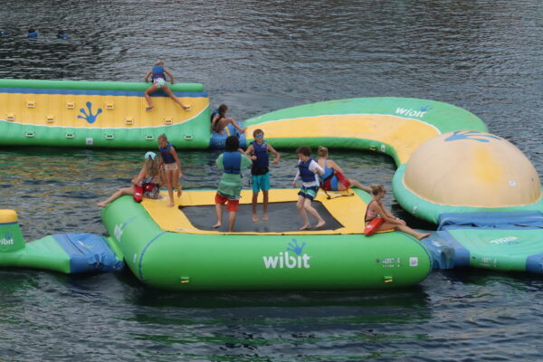 a group of campers playing on the Wibit in the H2O Woah Zone.