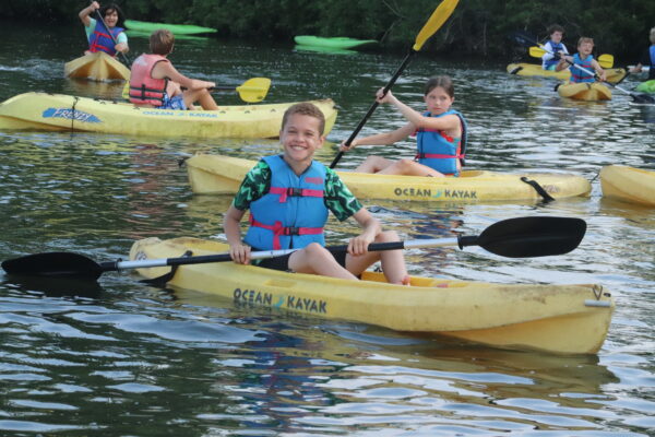a group of kids kayaking on Lake Tippecanoe.