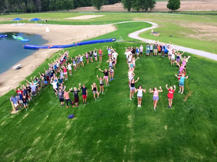 Arial photo of campers standing in the shape of the number "100" to celebrate their 100th year.